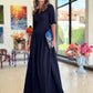 Long dark blue dress with pleats. Golden color detail in neckline