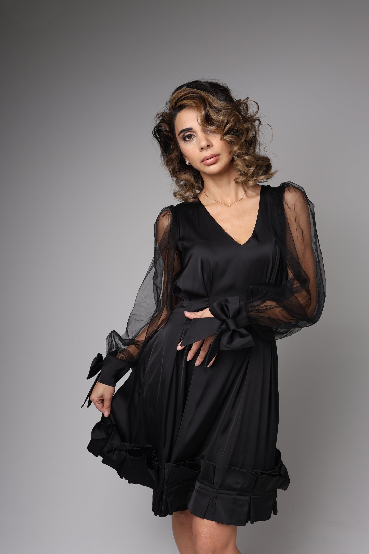 Elegant black satin dress with bows