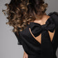 Elegant black satin dress with bows