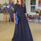 Long dark blue dress with pleats. Golden color detail in neckline